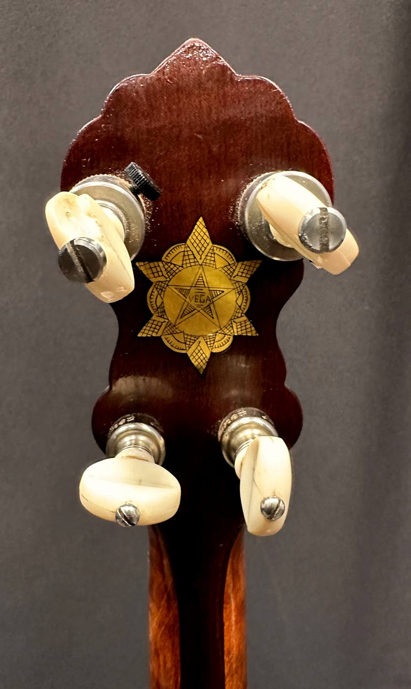 Engraved brass and pearl “Vega Star” inlay behind the peghead